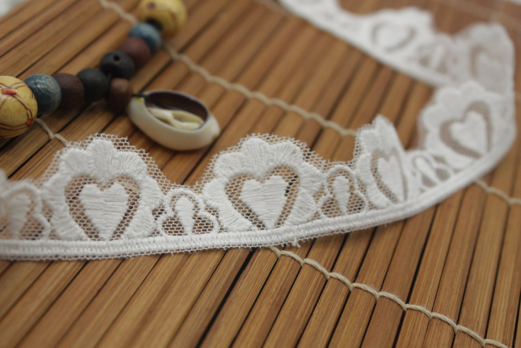 White cotton lace ribbon with heart pattern and scalloped edge, 1 inches wide